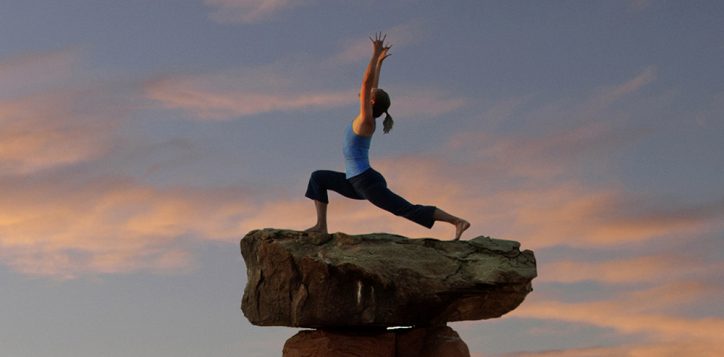 caucasian-woman-practicing-yoga-on-top-of-rock-formation-2